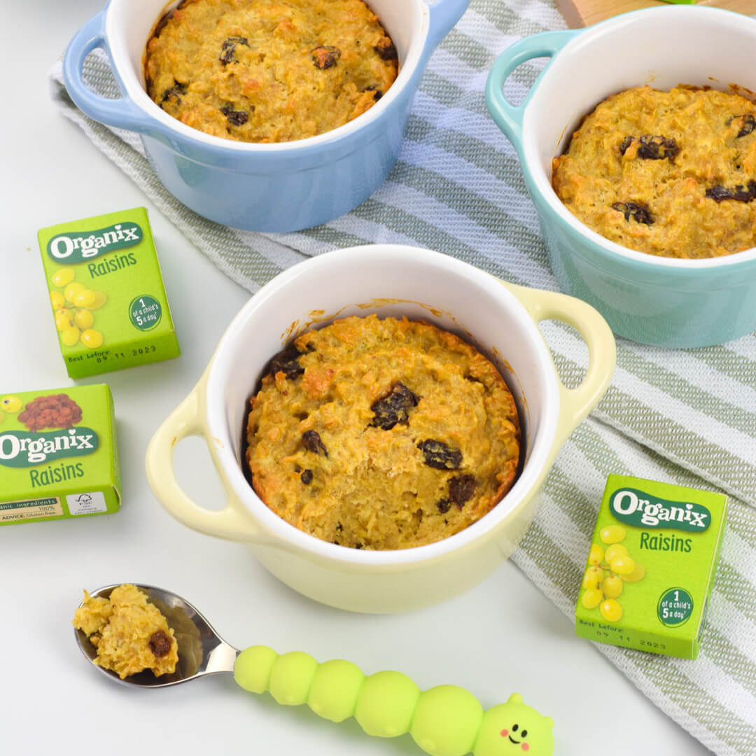 3 small ramekins of vanilla raisin baked oats next to 3 boxes of Organix raisins