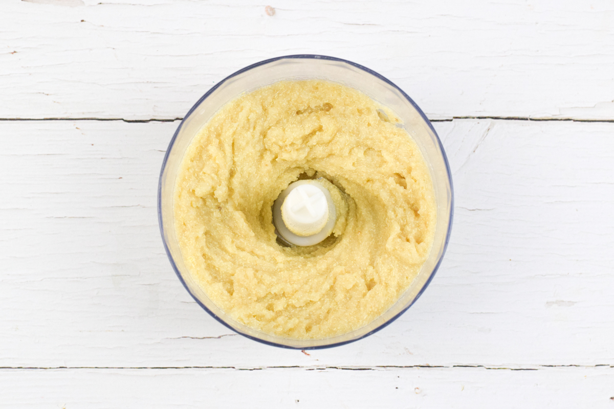 A food processor with cooked, blended quinoa