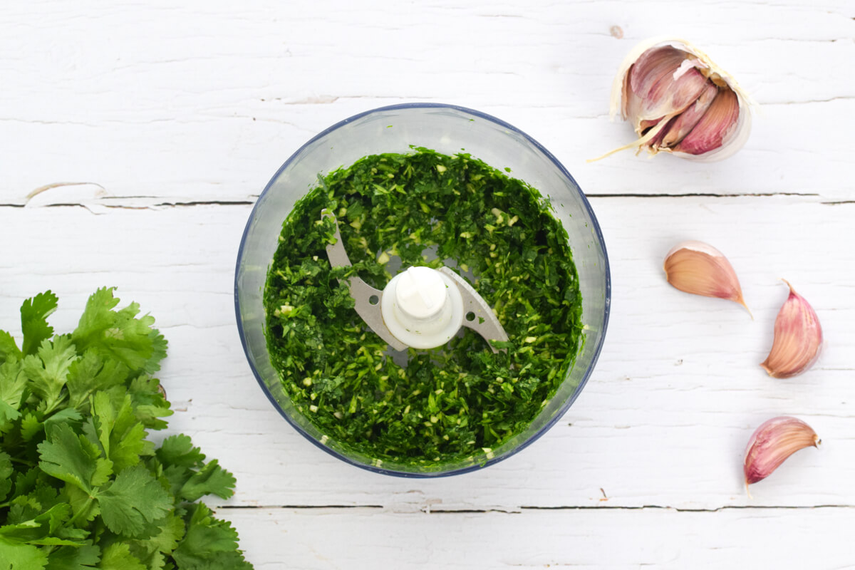 A food processor with garlic and coriander