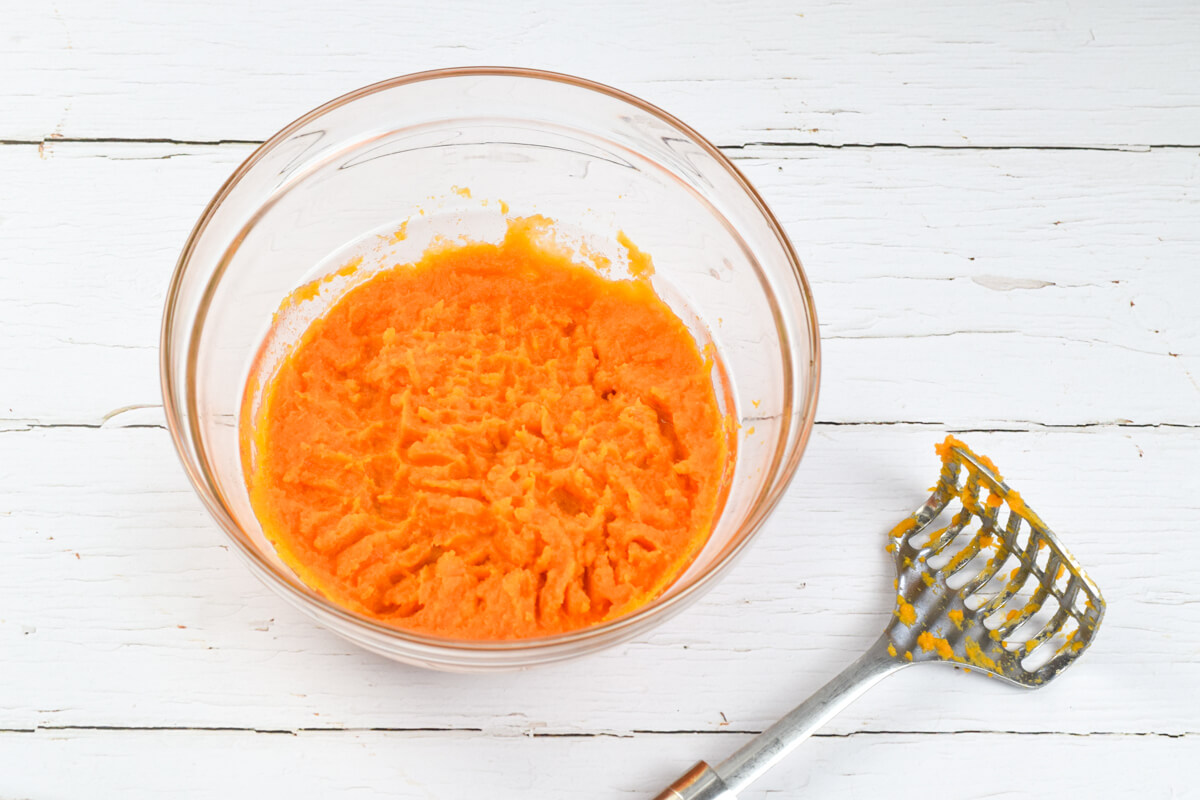 A glass bowl with mashed sweet potato