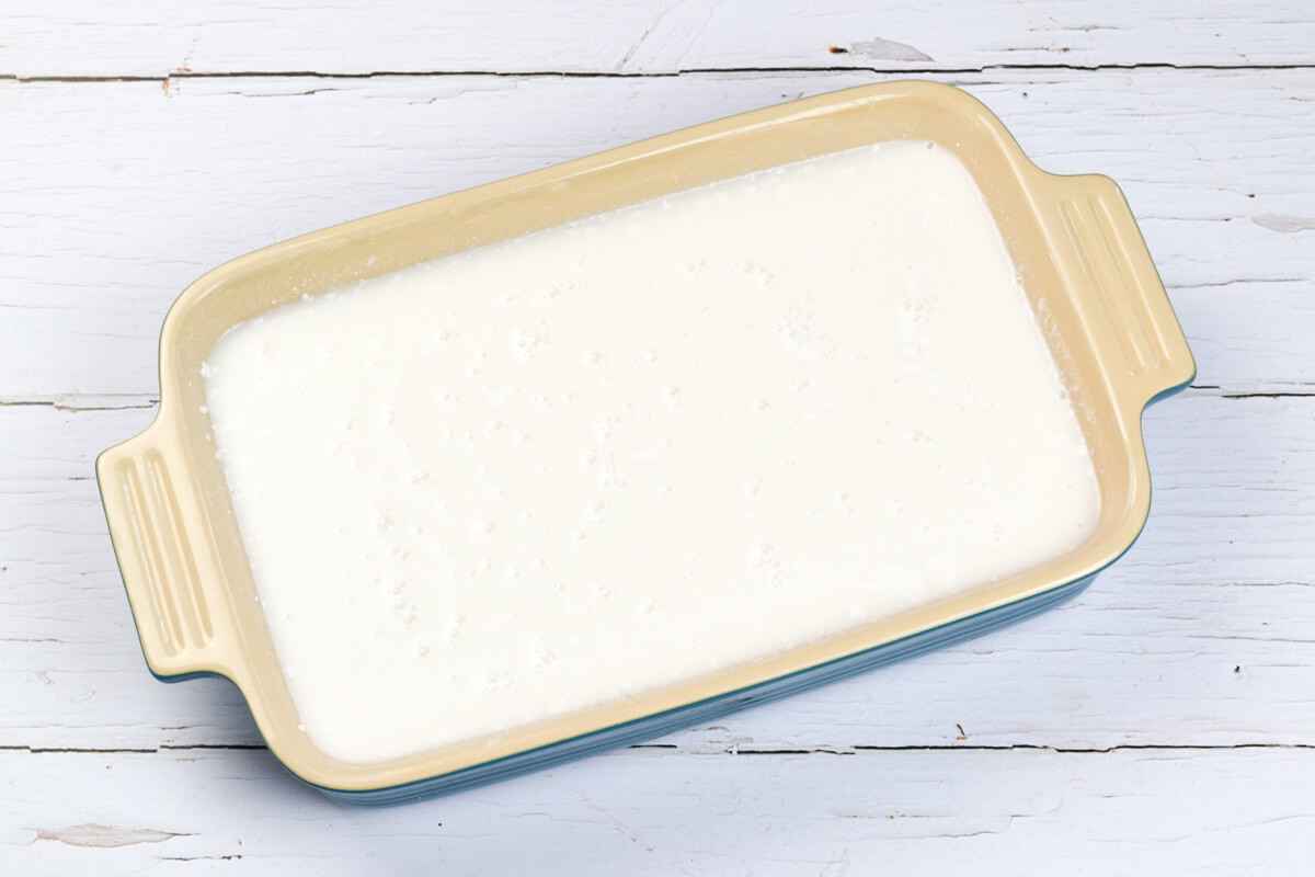 A large ovenproof dish with pudding rice, coconut milk, water and vanilla extract 