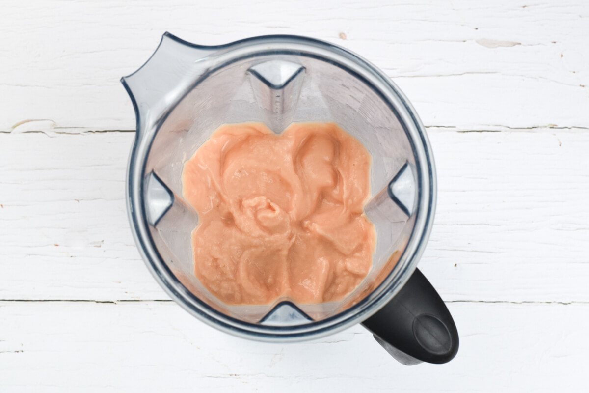 A food processor with blended frozen watermelon and banana